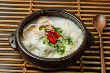 Korean style noodle soup with dumplings, mandu kalguksu