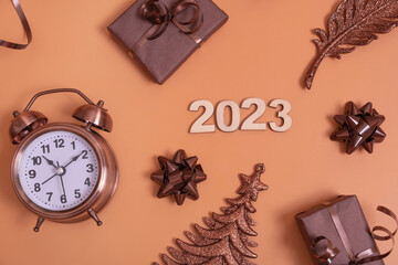 Flat lay 2023 new year numbers on color background with alarm clock and gift boxes top view