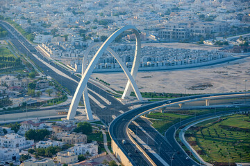 Aerial view of Al Wahda Bridge The Tallest Monument of Doha City. known as 56 Bridge of Arch
