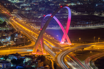 Fototapeta na wymiar Aerial view of Al Wahda Bridge The Tallest Monument of Doha City. known as 56 Bridge of Arch