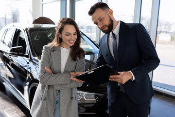 car dealership consultant talks about the loan program to the buyer of a new car, car insurance...