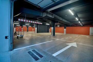 Spacious well-lit underground garage in the warehouse facility