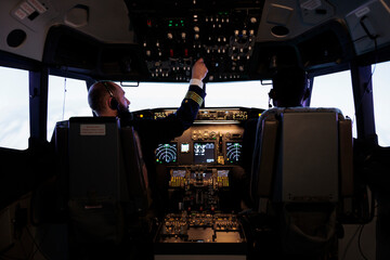 Team of diverse airliners flying airplane with engine lever and power switch on dashboard command, using buttons on control panel navigation to fly aircraft jet, professional aviation service.