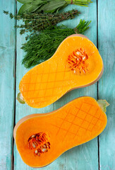 Fresh butternut squash with thyme and sage on a wooden surface.  Butternut Pumpkin . Healthy food concept.