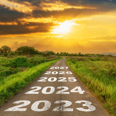 Empty asphalt road and New year 2023 concept. Driving on an empty road to 2023 with sunset.