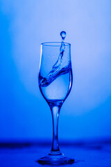 glass of water on blue