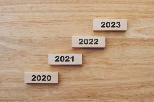 2020 to 2023 happy new year on wood block on wood table background. new year concept