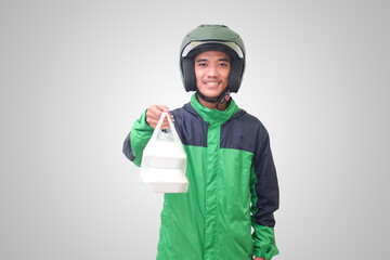 Portrait of Asian online taxi driver wearing green jacket and helmet holding food wrapped in foam plastic box. Isolated image on white background