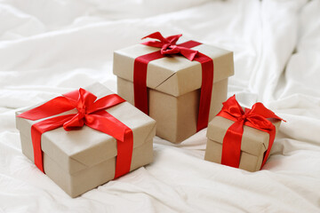 christmas and valentine's day concept - gift boxes over white blanket