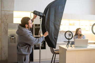 Video blogger and the cameraman preparing for shooting a vlog