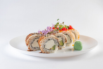 sushi on a plate with cheese and vasabi