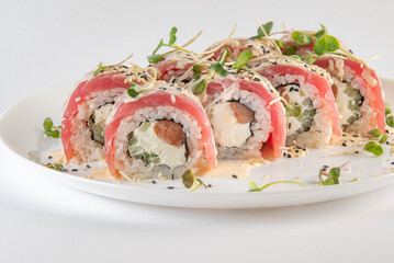 red sushi on a plate with souse