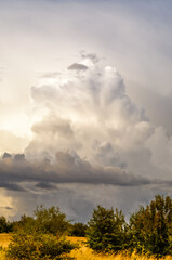 layered storm clouds, heavy rain clouds, landscape before sunset, spectacularly lit by sunlight