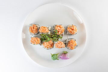 white sushi with salmon on a plate with vasabi