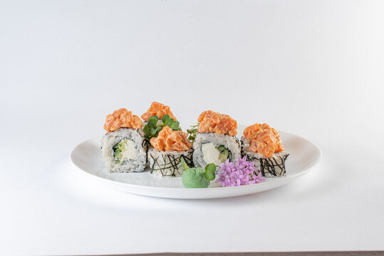 white sushi with salmon on a plate with vasabi