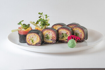 Black suhi rolls on white background