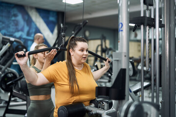 Fototapeta na wymiar Caucasian woman with overweight training at the gym