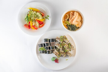 Lunch set. Sushi rolls, soup and salad