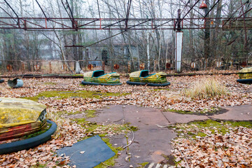 Abandoned bumper cars in the amusement park of Pripyat city in Chernobyl Exclusion Zone, Ukraine