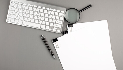 Keyboard and paper on grey background , copy space