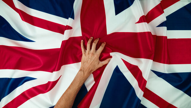 Hand clutches the flag of England for the death of Queen Elizabeth