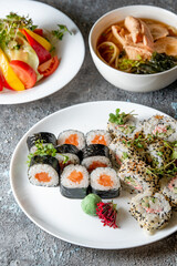 Lunch set. Sushi rolls, soup and salad