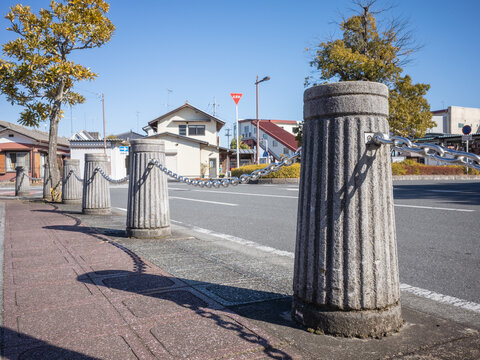 Concrete Pillars Connected With Iron Chains On Along The Side Walk