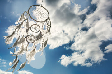 Dream catcher on blue sky background with copy space