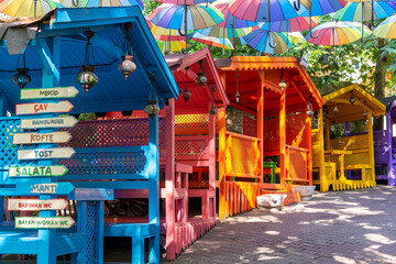 Colorful huts with umbrellas hanging in an Istanbul neighborhood.