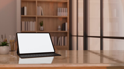 Portable tablet mockup on modern marble tabletop workspace over blurred home working room