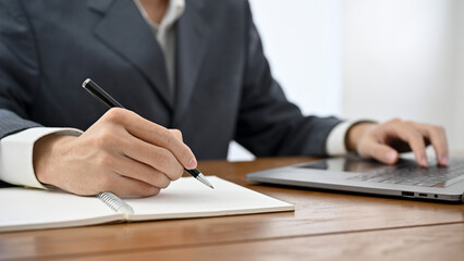 Professional Asian businessman, lawyer or financial consultant working at his office desk