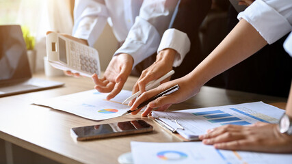 Group of expert financial consultant analysts in the meeting, calculating accounts and sales