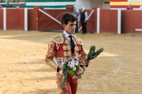 Male matadore with flowers on arena