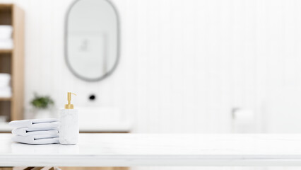 White marble tabletop with towels, shampoo bottle and empty mockup space over blurred bathroom