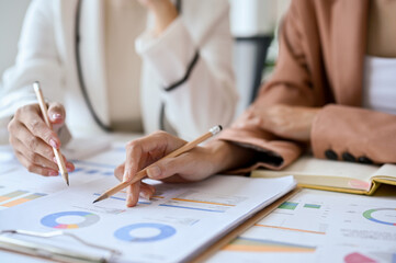 cropped, Two businesswomen or financial analysts working together
