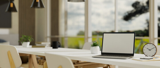 Laptop mockup on white meeting table or working table in modern minimal co-working space