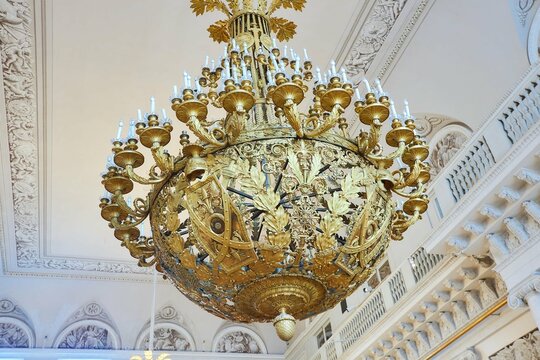 St. Petersburg, Russia - May 27, 2021: Hermitage Museum, large chandelier with gilding for hall lighting. Palace interior details.
