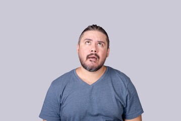 A sarcastic man reacts to a dumb comment. Saying duh while looking up and rolling his eyes.