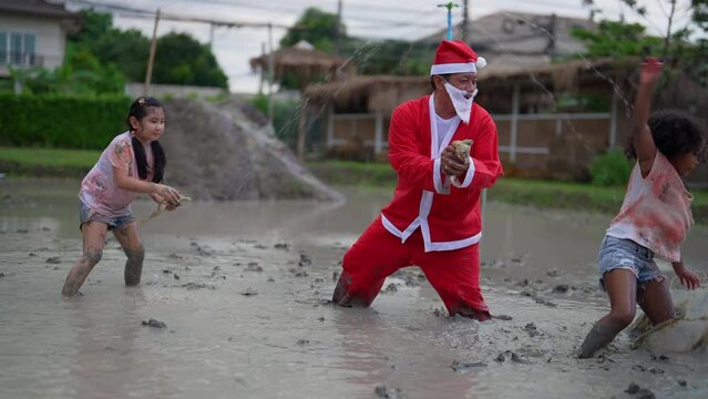 farmer dress Santa play with kid by catch frog in the muddy pond, one kid scary and move away

