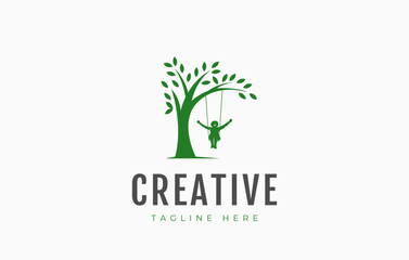 Obraz premium Child Playing Swing Under Tree Logo Design Template.
