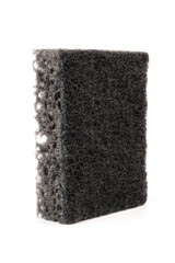 Black sponge used for washing dishes. Has two surfaces which are rough and smooth.
