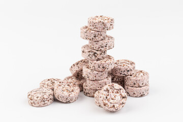 Heap of medicine colored pills, tablets on a white background