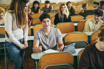 Fototapeta premium Mature teacher working with students inside classroom at school university - Focus on left guy face