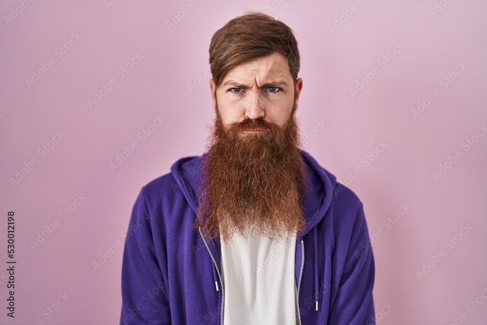 Canvas Prints caucasian man with long beard standing over pink background depressed and worry for distress, crying