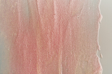 Beauty gel texture with pink and golden particles. Shining highlighter background with brush strokes