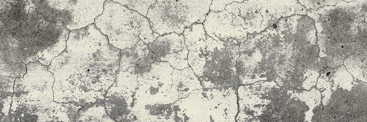 Obraz premium Old wall with cracked plaster. Weathered rough surface. Wide panoramic texture for background and design.