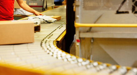 Parcel on conveyor belt in a warehouse.