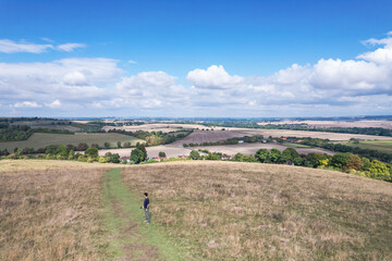 Hiking man walking in the field, Amazing view of Goring and Streatley, village town near Reading,...