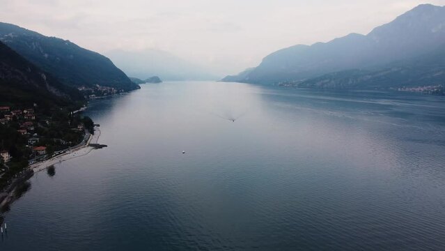 Coastline of Lake Garda. Aerial view of Bardolino, Lake Garda, Italy. Aerial shot of lake near city and mountains against sky. Lago di Garda, Italy: Aerial view of largest Italian Lake Garda. 