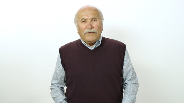 Loving Old Man Looking At Camera. Studio Portrait Of Old Man Isolated On White Background. Portrait Of A Thoughtless Smiling Neutral Old Man.